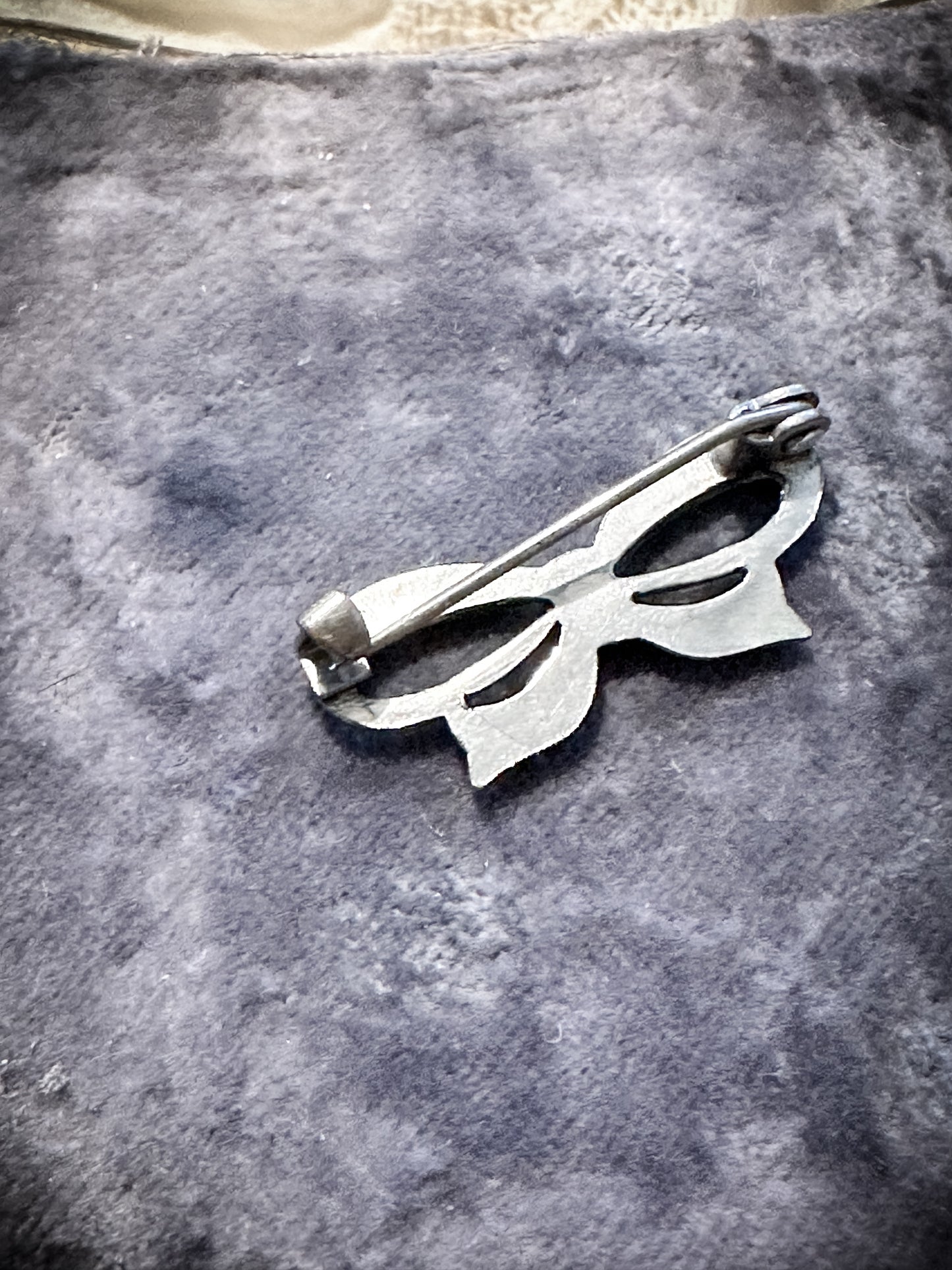 A miniature marcasite bow brooch