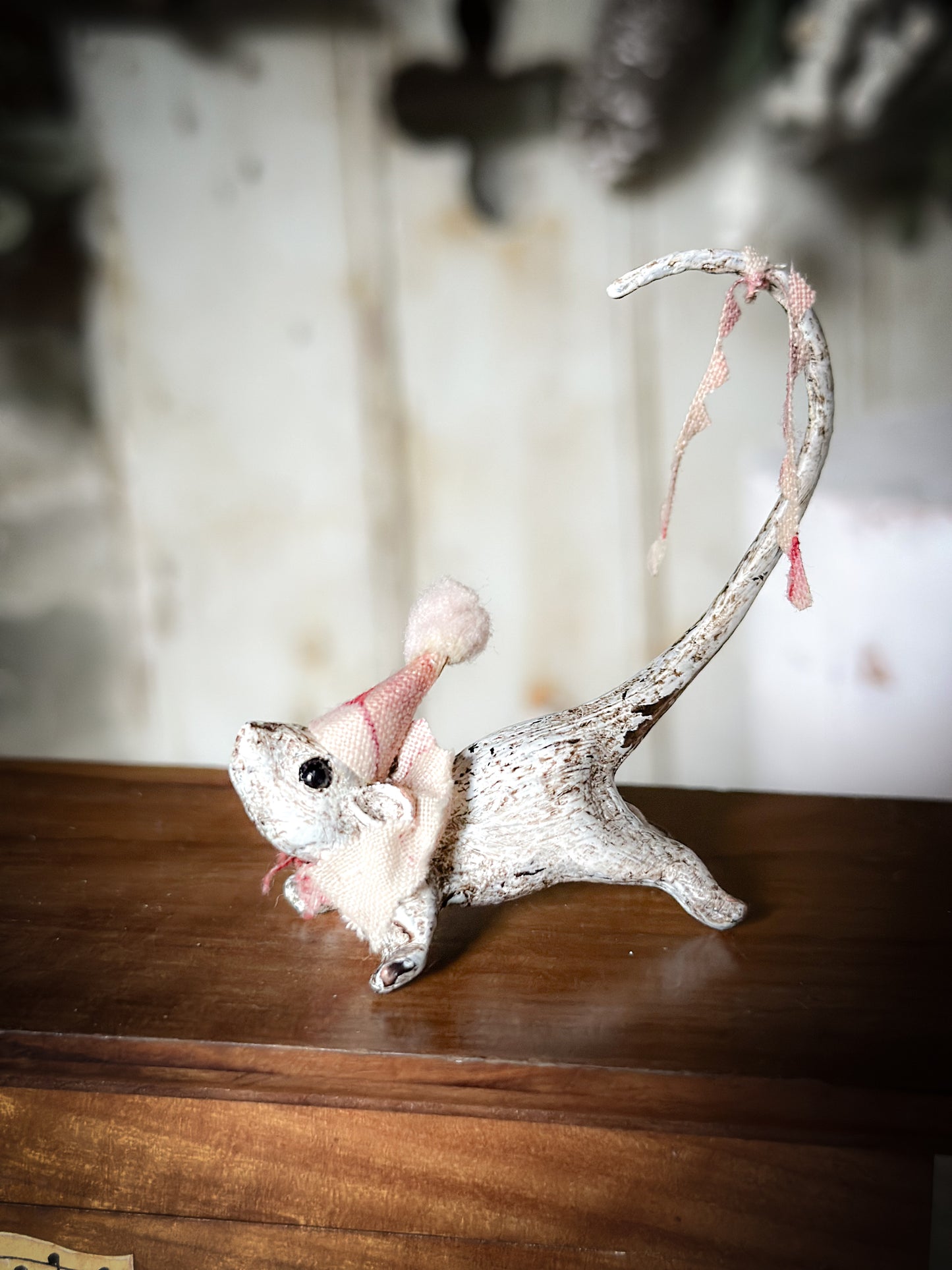 A cold painted brass “night before Christmas mouse” with a fabric ruffle and Christmas hat