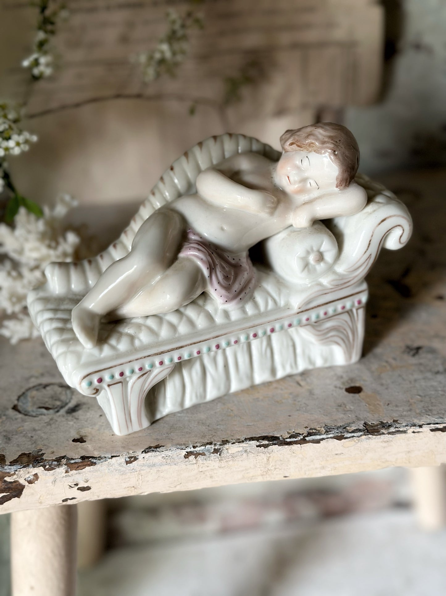 A beautiful antique Staffordshire pottery reclining lady figurine